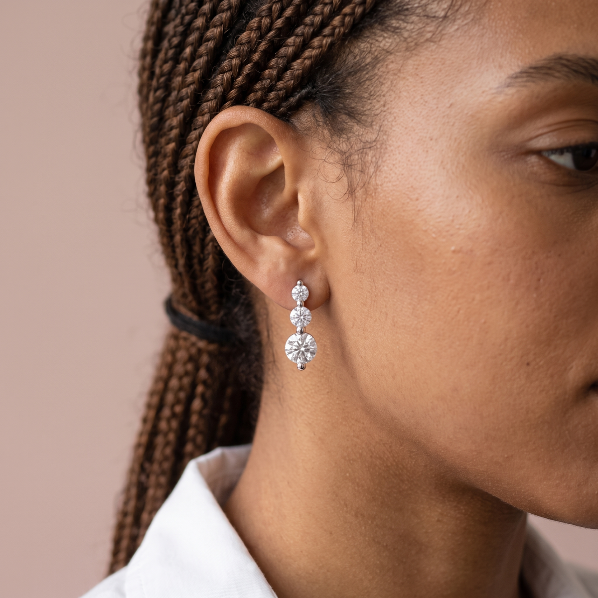 Trio Stud Earrings worn, close-up portrait