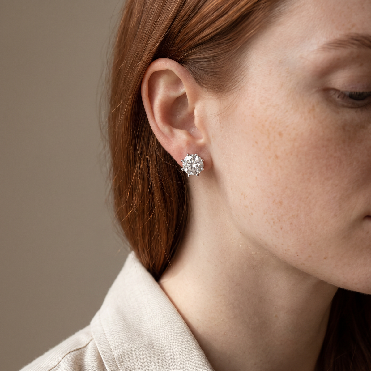 Corona Stud Earrings worn, close-up portrait