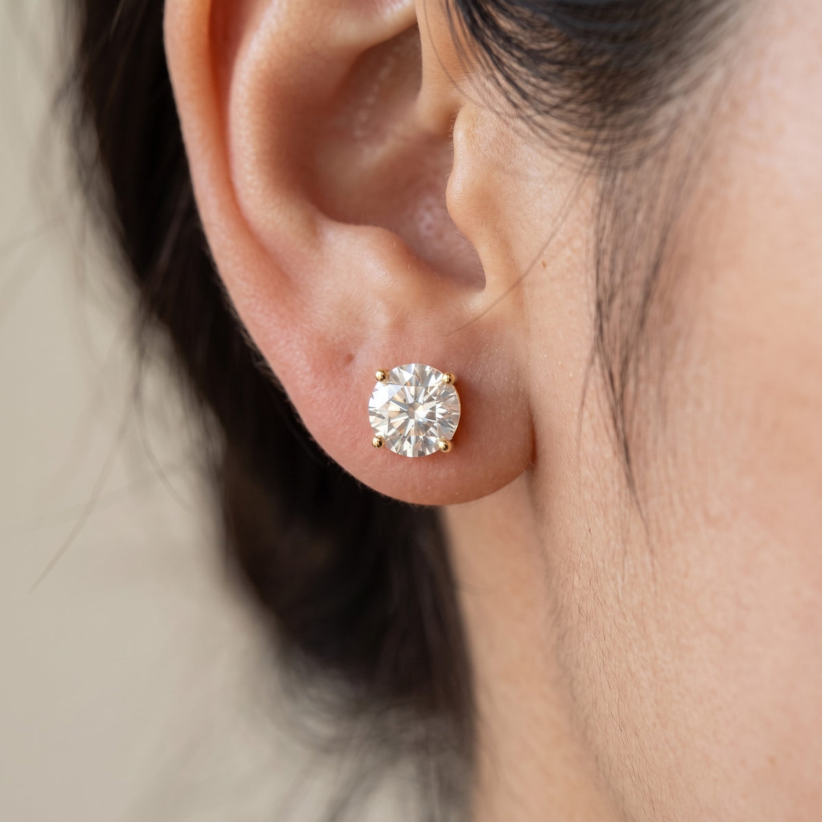 Prima Stud Earrings in gold worn on ear