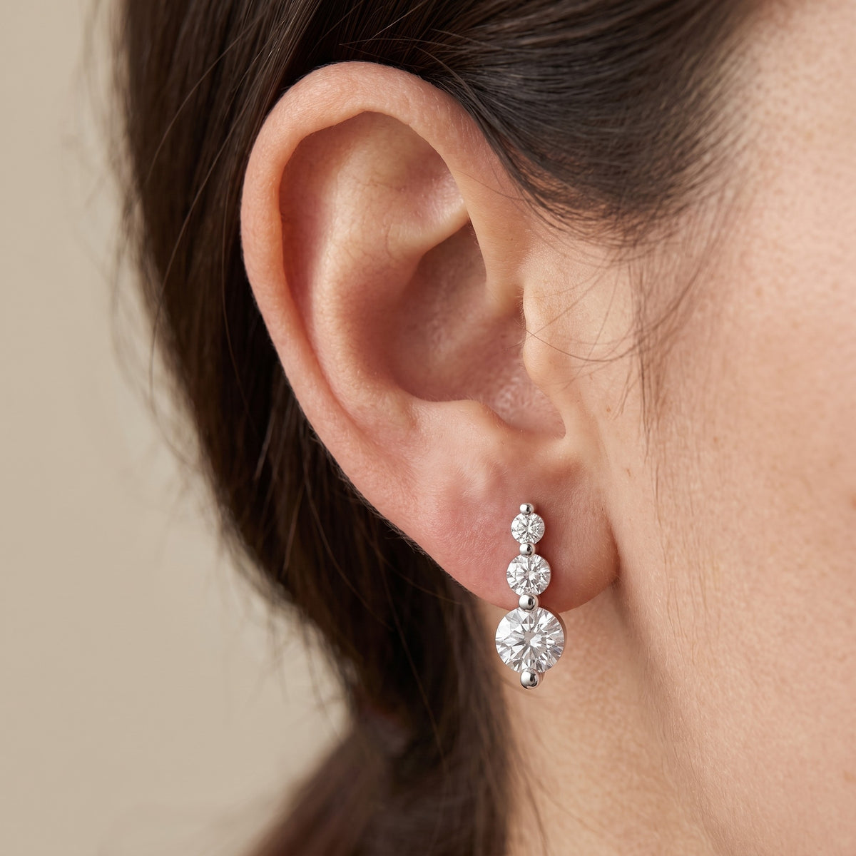 Trio Stud Earrings worn on ear