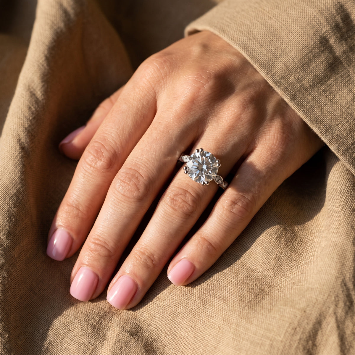 Prima Ala Ring worn on hand on raw linen