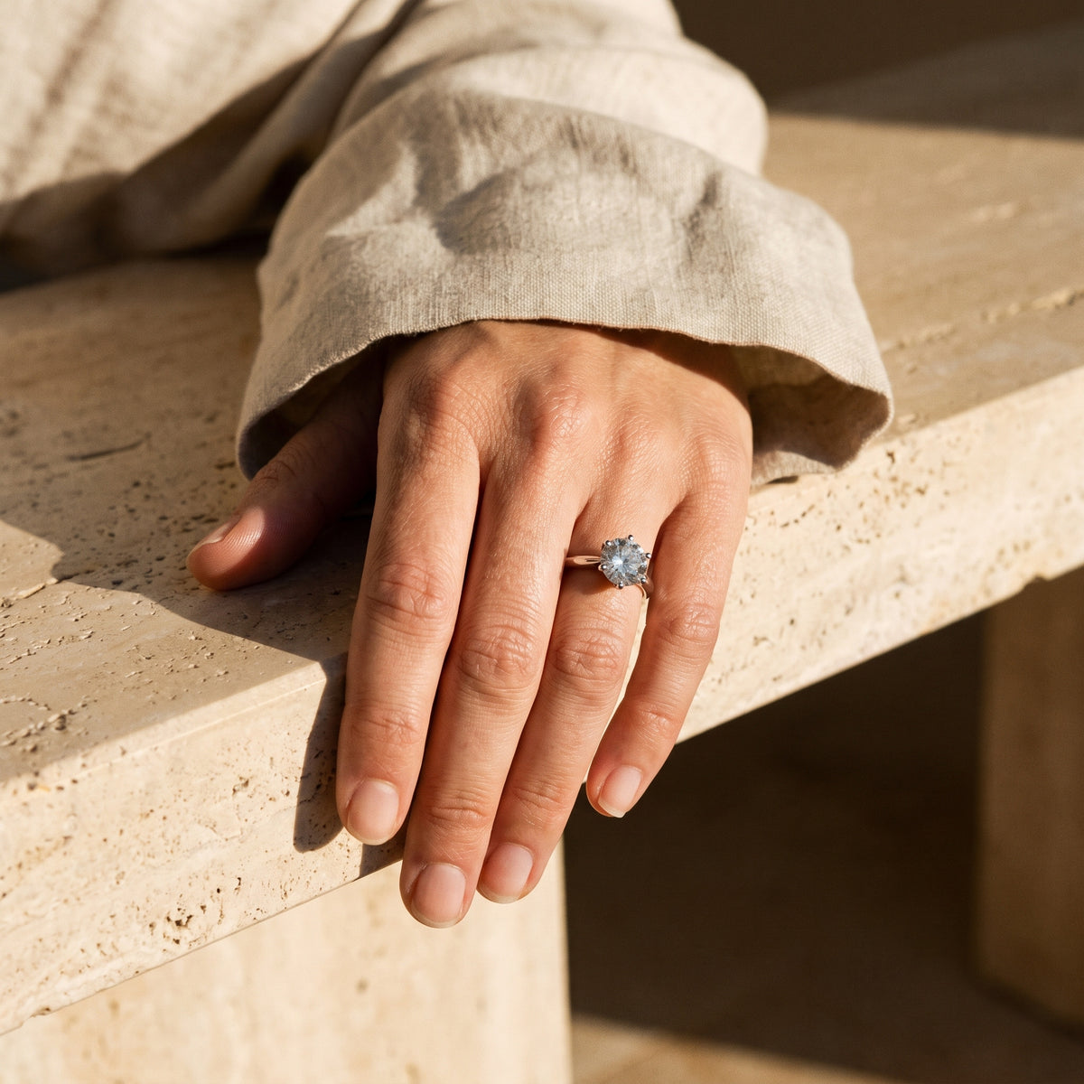 Prima Ring worn on hand on a travertine ledge in afternoon sun